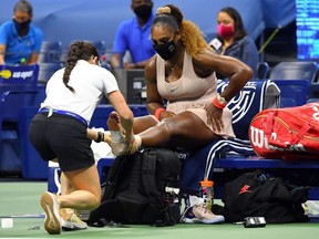 Serena Williams gets treatment for her left ankle during a match against Victoria Azarenka in the women's singles semifinals of the 2020 U.S. Open at USTA Billie Jean King National Tennis Center, in Flushing Meadows, N.Y., Thursday, Sept. 10, 2020.