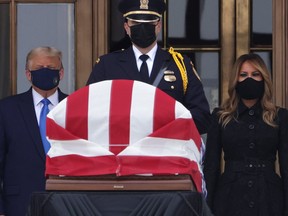 U.S. President Donald Trump and first lady Melania Trump pay their respects to Associate Justice Ruth Bader Ginsburg's flag-draped casket on the Lincoln catafalque on the west front of the U.S. Supreme Court in Washington, DC, on Sept. 24, 2020.