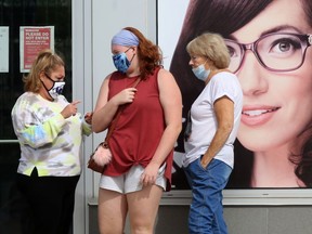 Many people are wearing masks while entering businesses in Winnipeg on Saturday.