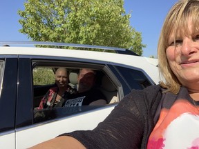 Marla Paul-Merasty, a Winnipeg marriage commissioner at It's Your Wedding, poses for a selfie with Bonnie Funk and new husband Michael following their drive-thru wedding on Friday, Sept. 11, 2020. Paul-Merasty decided to use the driveway of her country home as a wedding venue due to COVID restrictions on large gatherings such as weddings.