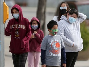 A group of people wear masks, in Winnipeg on Tuesday.