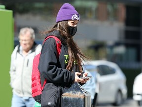 A person wearing a mask walks on Portage Avenue in Winnipeg on Wed., Sept. 16, 2020. Kevin King/Winnipeg Sun/Postmedia Network