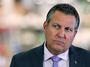 Justice Minister Cliff Cullen listens to a question during a press conference detailing a retail crime task force, at Grant Park Shopping Centre in Winnipeg, on Tuesday, Sept. 22, 2020.