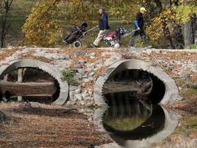 Golfers intersect across a bridge at Windsor Park Golf Course in Winnipeg on Tuesday, Sept. 29, 2020.