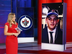 SECAUCUS, NEW JERSEY - OCTOBER 06: With the tenth pick of the 2020 NHL Draft, Cole Perfetti from Saginaw of the OHL (R) is selected by the Winnipeg Jets at the NHL Network Studio on October 06, 2020 in Secaucus, New Jersey.  (Photo by Mike Stobe/Getty Images)