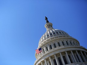 A U.S. flag flies in front of the dome of the U.S. Capitol February 12, 2013 on Capitol Hill in Washington, D.C.
