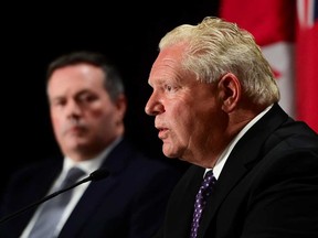 Ontario Premier Doug Ford speaks as Alberta Premier Jason Kenney looks on during a press conference in Ottawa on Friday, Sept. 18, 2020.