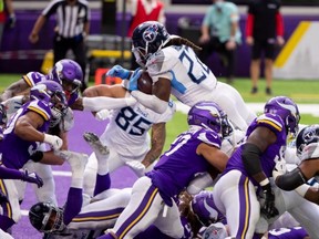 Titans running back Derrick Henry (22) scores a touchdown in the third quarter against the Vikings at U.S. Bank Stadium in Minneapolis, Sept. 27, 2020.