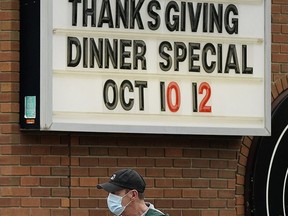 A man walks past a downtown Edmonton restaurant on Friday.