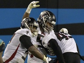 Falcons' Grady Jarrett (left), Steven Means (centre) and Deion Jones (right) celebrate sacking Panthers QB Teddy Bridgewater during fourth quarter NFL action at Bank of America Stadium in Charlotte, N.C., Thursday, Oct. 29, 2020.
