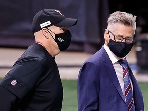 Head coach Dan Quinn of the Atlanta Falcons walks off the field with general manager Thomas Dimitroff after their 23-16 loss to the Carolina Panthers at Mercedes-Benz Stadium on October 11, 2020 in Atlanta.