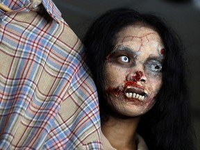 Online clothes seller, Kanittha Thongnak, 32, livestreams selling dead people's clothes in zombie makeup in Bangkok, Thailand October 10, 2020.