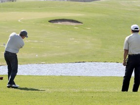 A pair of golfers tee off at the John Blumberg Golf Course. The City is considering selling the 27-hole property in Headingley.