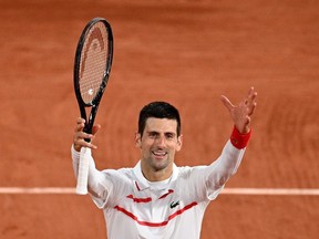 Serbia's Novak Djokovic celebrates after winning against Colombia's Daniel Elahi Galan at the end of their men's singles third round tennis match on Day 7 of The Roland Garros 2020 French Open tennis tournament in Paris on October 3, 2020.