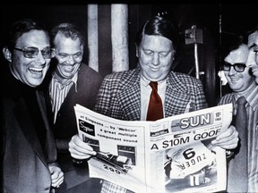 Former publisher Doug Creighton, left, holds the first copy of The Toronto Sun on Nov. 1, 1971, with Ray Biggart (centre) and Peter Worthington (right) and general manager Don Hunt (left).