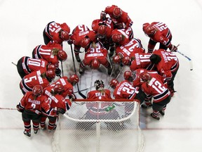 Members of Team Canada huddle around goaltender Sami Jo Small prior to a game against Finland at the 4 Nations Cup in 2004 
in Lake Placid, N.Y.
