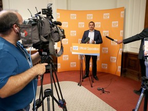 Media practice social distancing during a press conference by provincial NDP leader Wab Kinew in the party caucus room at the Manitoba Legislative Building in Winnipeg on Tuesday.