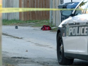 A running shoe and a medic bag sit in the backlane between Boyd and College Avenues after an officer-involved shooting in Winnipeg on Wed., Oct. 7, 2020. Kevin King/Winnipeg Sun/Postmedia Network