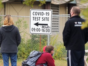 People line up for Covid-19 testing at Thunderbird House on Main Street in Winnipeg on Thursday, Oct. 8, 2020.