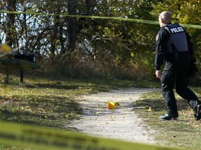 Multiple evidence markers were visible on the entry to Don Gerrie Park and along the trail off Churchill Drive in Winnipeg after a body was discovered in the Red River on Monday, Oct. 12, 2020.