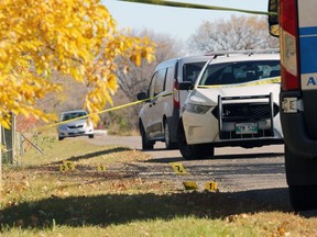 Multiple evidence markers were visible on the entry to Don Gerrie Park and along the trail off Churchill Drive in Winnipeg after a body was discovered in the Red River on Monday.