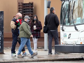 People with masks make their way on to a bus in the Polo Park area of Winnipeg on Wed., Oct. 14, 2020. Kevin King/Winnipeg Sun/Postmedia Network