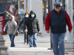 People walking along Graham Avenue, in Winnipeg.  Many people are wearing masks outside while in public. Friday, October, 16, 2020.