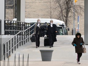 Lawyers make their way down a ramp from the temporary entrance to the Law Courts building on Broadway in Winnipeg on Tuesday.