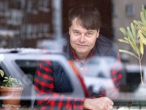 Co-owner Cam Loeppky peers out the window of the Good Will Social Club on Portage Avenue in Winnipeg on Thurs., Oct. 29, 2020. Kevin King/Winnipeg Sun/Postmedia Network