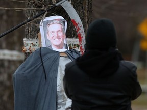 Community members and activists placed cardboard tombstones across from Manitoba Premier Brian Pallister’s Wellington Crescent home in Winnipeg, early Saturday morning. In a press release, organizers said the Halloween display was installed to recognize the Manitobans who have died of COVID-19 and in protest of the provincial government’s inaction to quell the massive second wave of cases that has been building over the last few weeks. The tombstones note the deaths as well as deadly outbreaks at several personal care homes including Parkview Place and Heritage Lodge personal care homes. As well, a Grim Reaper was set up with Pallister's picture attached.