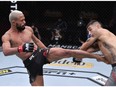 LAS VEGAS, NEVADA - NOVEMBER 21: In this handout image provided by UFC, (L-R) Deiveson Figueiredo of Brazil kicks Alex Perez in their flyweight championship bout during the UFC 255 event at UFC APEX on November 21, 2020 in Las Vegas, Nevada.