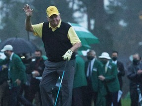 Honorary starter and Masters champion Jack Nicklaus waves after playing the opening tee shot on the first tee during the first round of the Masters at Augusta National Golf Club on on Thursday.
