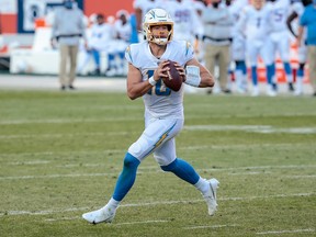 Chargers quarterback Justin Herbert rolls out to pass against the Denver Broncos.