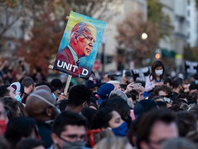 People celebrate at Black Lives Matter Plaza across from the White House in Washington on November 7, 2020, after Joe Biden was declared the winner of the 2020 presidential election.