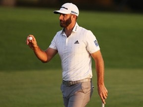 Dustin Johnson reacts after making a par putt on the 18th green during the third round of the Masters at Augusta National on Saturday. Johnson heads into the final round with a four-stroke lead.