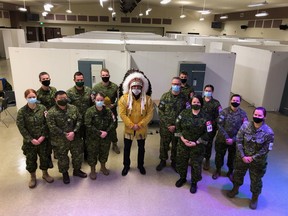 Onekanew (Chief) Christian Sinclair poses with members of the Canadian Armed Forces, who had been deployed to Opaskwayak Cree Nation earlier this month to help with an outbreak at a local personal care home. Photo by Onuschekew Jennifer Flett