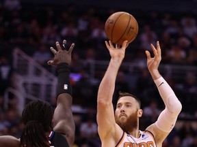 Former Phoenix Sun Aron Baynes attempts a shot over the Clippers’ Montrezl Harrell. Baynes will sign a two-year deal with the Raptors worth 14.3 million.