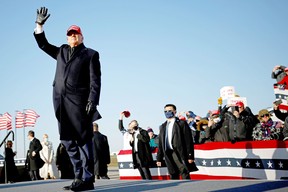 U.S. President Donald Trump waves during a campaign rally at Dubuque Regional Airport in Iowa, U.S., November 1, 2020.