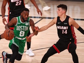 Celtics guard Kemba Walker (left) dribbles the ball against Heat guard Tyler Herro (right) during the Eastern Conference Finals of the 2020 NBA Playoffs at AdventHealth Arena, Lake Buena Vista, Fla., Sept. 23, 2020.