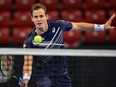 Vasek Pospisil hits a return against Richard Gasquet during the semifinal match of the ATP 250 Sofia Open in Sofia, Bulgaria, Friday, Nov. 13, 2020.