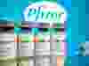 Vials with a sticker reading, “COVID-19 / Coronavirus vaccine / Injection only” and a medical syringe are seen in front of a displayed Pfizer logo in this illustration taken Oct. 31.