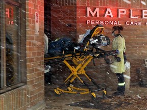 A stretcher is wheeled into the Maples Long Term Care Home on Mandalay Drive in Winnipeg on Monday, Oct. 26, 2020.