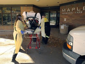 Patient Transport Services personnel stretcher a man into Maples Long Term Care Home on Mandalay Drive in Winnipeg on Tuesday, Nov. 3, 2020.