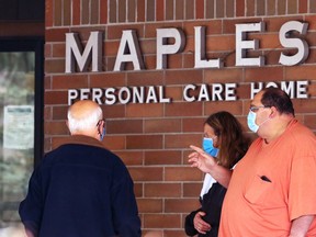 Mike Radocaj (right) and other family members look for answers about his mother-in-law at Maples Personal Care Home on Mandalay Drive in Winnipeg on Sunday.