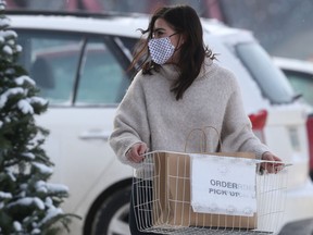 Chelsea, from Mad About Style Boutique, on Academy Road, arranges a curtsied pickup, in Winnipeg.  Friday, Nov. 20, 2020.