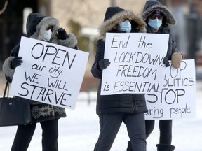 A very small number of COVID-19 restriction protesters attended the Manitoba Legislative Building on Saturday.