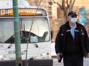 A transit operator wearing a face mask walks on Broadway in Winnipeg on Mon., Nov. 23, 2020. Kevin King/Winnipeg Sun/Postmedia Network