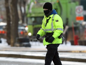 A G4S security guard member crosses Memorial Boulevard in Winnipeg on Thurs., Nov. 26, 2020. The firm was hired to help enforce health orders. Kevin King/Winnipeg Sun/Postmedia Network