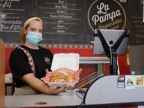 Yohanna Basgall shows off some gourmet empanadas. She has worked the till at La Pampa in Winnipeg for a month. She says she loves being able to share Argentine food with the people of Winnipeg.