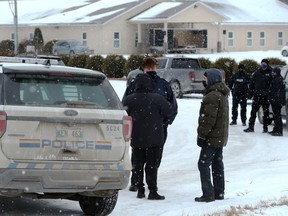 RCMP and Manitoba Justice officials congregate in front of Church of God, south of Steinbach, Man., on Sunday, Nov. 29, 2020.